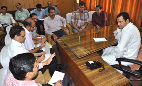 Minister of State for R&B, Javed Ahmed Dar chairing meeting of officers of ERA and NBCC at Jammu on Tuesday.