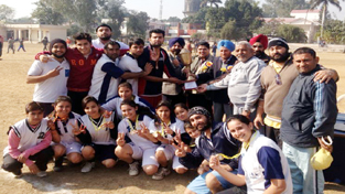 Jubilant players of Trikuta Korfball Club posing for a photograph while receiving winners trophy from the chief guest on Sunday.