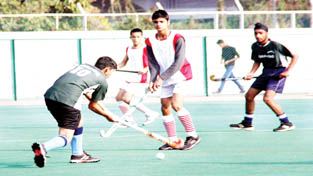 Player dodging and dribbling during a match of the 1st Shaheed Bhagat Singh Memorial Hockey Tournament at KK Hakhu Astroturf Stadium in Jammu on Wednesday. -Excelsior/Rakesh