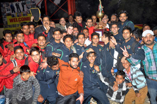 Jubilant J&K Bank team players posing for a group photograph after clinching 8th Christmas Gold Cup Football title in Jammu on Wednesday. -Excelsior/Rakesh