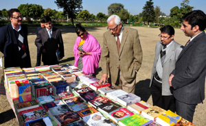Governor, N N Vohra having a look at books which were gifted to Civil Services Institute Reasi on Friday.