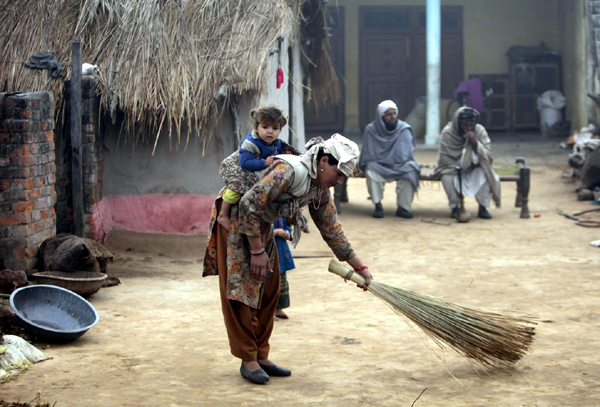 A Gujjar lady cleans her shelter house on Jammu’s outskirts. —Excelsior/Rakesh