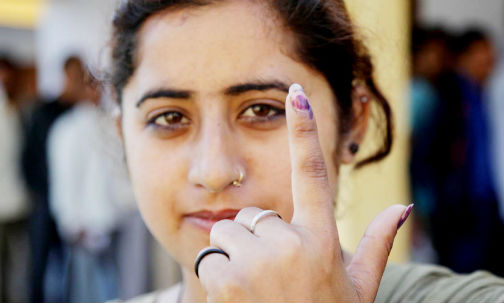 A first time voter shows her ink marked finger after casting her vote at a polling station in RS Pura on Thursday. (UNI)