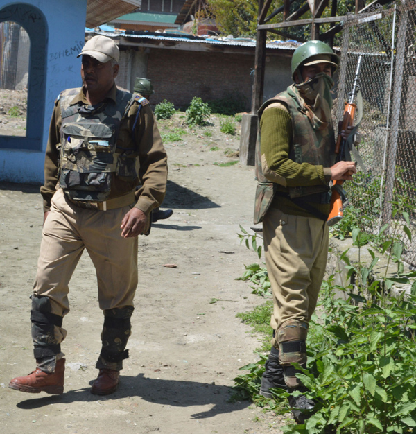 Security personnel take position at the spot of grenade attack by militants in Khanyar, Srinagar on Sunday. -Excelsior/ Amin War