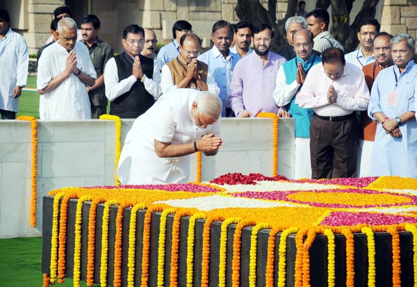 Prime Minister designate Narendra Modi paying tribute to Father of the Nation Mahatma Gandhi at Rajghat before his oath as Prime Minister of India in New Delhi on Monday. (UNI )
