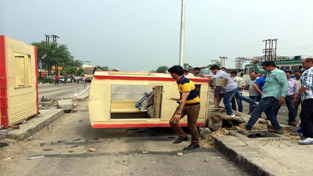 BJP activists smashing Toll Plaza at Sarore on Tuesday. -Excelsior/Gautam