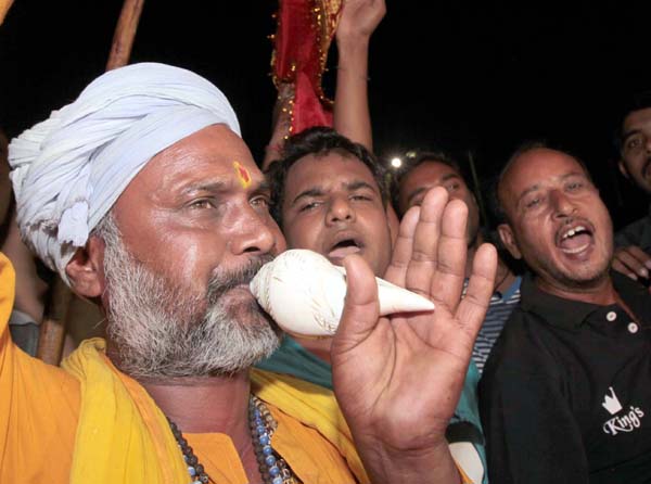 A Sadhu blows coonch shell as first batch of Amarnath yatra departs from Bhagwati Nagar base camp in Jammu on Friday. —Excelsior/Rakesh