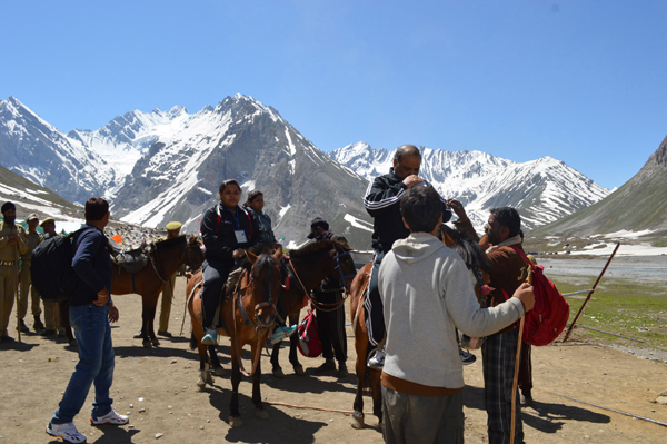 Yatris riding on horses on way to holy cave from Baltal on Saturday. -Excelsior/ Sajad Dar