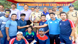 Simula Club players receiving trophy from DIG Jammu-Kathua Range, Shakeel Ahmed Beig at KC Sports Club ground in Jammu on Saturday.