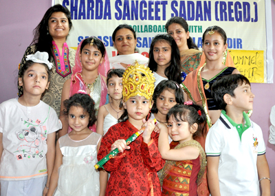 Children posing for a group photograph during the workshop on music and culture.