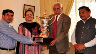 Governor presenting silver rolling trophy to Principal of GCW, M.A Road, Srinagar.