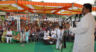 Minister for Housing Raman Bhalla addressing public gathering at Lower Gaddigarh on Saturday.