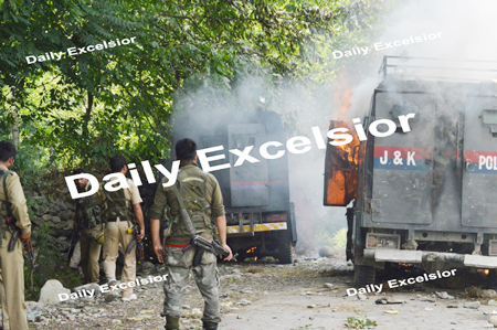 July- 05,2014- TRAL : Protesters torch two police armed vehicles in Tral town of south Kashmir's Pulwama district early this morning after a brief encounter between forces and militants. One militant was killed in the encounter, on Saturday. Excelsior/ Sajad Dar