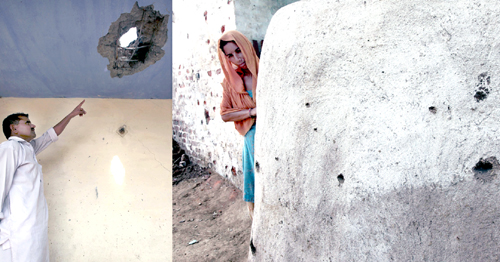 A man points to his roof damaged in mortar shell while a woman looks at the wall hit by several bullets in her house at village Gharana and Gharani in Arnia Sector on Sunday.-Excelsior/Rakesh
