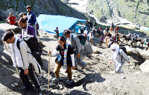Pilgrims crossing mountain at Sangam Top on Sunday.—Excelsior/Sajad Dar