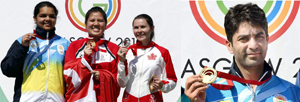 Singapore's Teo Shun Xie (C) celebrates after winning the women's 10m Air Pistol shooting event, flanked by second-placed India's Malaika Goel (L) and third-placed Canada's Dorothy Ludwig (R), India’s Abhinav Bindra displaying gold (extreme right ). (UNI)