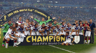Germany’s players posing for a photograph while celebrating World Cup victory against Argentina.