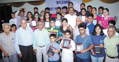 Union Minister, Dr Jitendra Singh giving awards to meritorious students of class 10th and 12th from displaced Kashmiri Pandit community at a function organized at New Delhi.