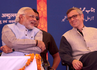 Prime Minister Narendra Modi and Chief Minister Omar Abdullah share smile during a function at Katra for inauguration of train on Friday. -Excelsior/Rakesh