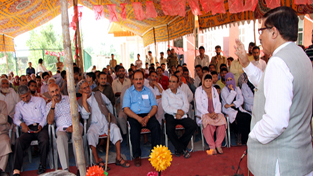 Speaker Legislative Assembly Mubarak Gul addressing public gathering at Srinagar on Monday.