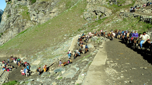 Amarnath pilgrims crossing Sangam Top on way to holy cave on Thursday. -Excelsior/Sajad Dar