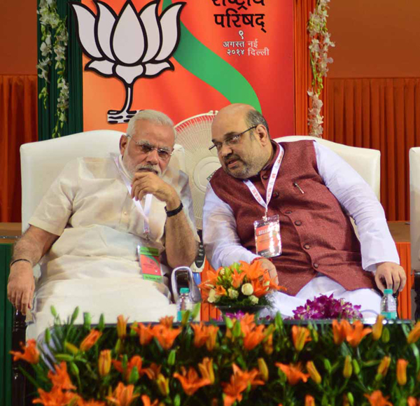 BJP president Amit Shah in consultation with Prime Minister Narendra Modi during the BJP National Council meeting in New Delhi on Saturday. (UNI)
