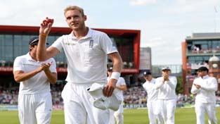 England's Stuart Broad holds the ball as he leaves the field after taking six wickets during the fourth Test match against India at the Old Trafford cricket ground in Manchester.