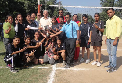 Winner team of Inter-Collegiate Volleyball Championship posing with trophy at Sports Stadium, JU, Jammu.