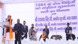The Union Home Minister, Shri Rajnath Singh addressing the gathering after presenting cheques for hiked compensation to 1984 anti-Sikh riot victims, at a function, in New Delhi on Friday.