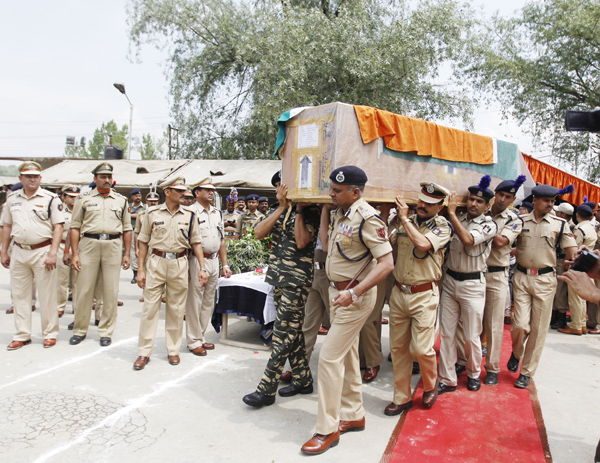 Director General of Police K Rajendra Kumar and senior CRPF officers carry the coffin containing the body of slain CRPF Jawans during a wreath laying ceremony on Tuesday -Excelsior/ Amin War