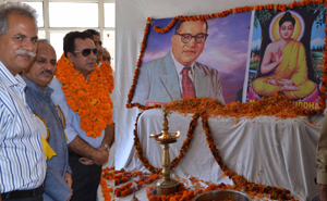 Minister for CAPD, Ch. Zulfkar Ali paying tribtues to Lord Buddha and Dr B R Ambedkar at Dogra Hall on Monday.