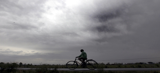 A man rides bicycle as clouds hover over Jammu City on Tuesday.— Excelsior/Rakesh
