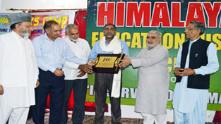 An artist being felicitated during art camp at Rajouri on Thursday.
