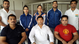 Four power lifters from J&K posing for group photograph after being selected in Indian team.
