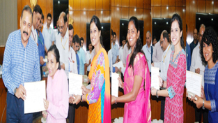 Union Minister Dr Jitendra Singh handing over certificates of merit to Ira Singhal, who has scored All-India first rank and the other toppers of IAS/Civil Services Exam 2014, at North Block, New Delhi on Monday.