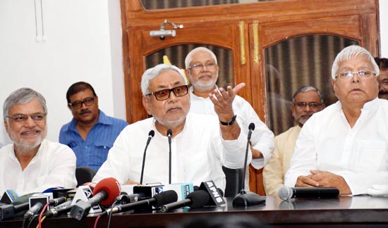 Chief Minister Nitish Kumar with RJD chief Lalu Prasad and Bihar Congress incharge C P Joshi jointly addressing a press conference in Patna on Wednesday. (UNI)