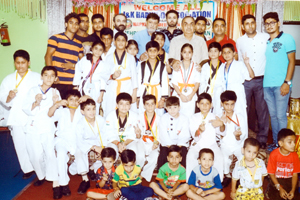 Medal winners of 1st District Hapkido Championship posing for a photograph along with dignitaries at Baby Caterers, Rehari in Jammu on Saturday.