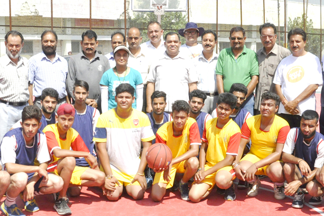 Players posing for a group photograph alongwith Joint Director Youth Services and Sports and other dignitaries during inaugural function of State Level Basketball tournament at MA Stadium in Jammu on Friday.