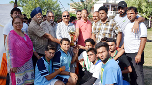 Winners of Handball Tournament posing for a group photograph alongwith chief guest Yudhvir Sethi and other dignitaries in Jammu on Thursday.