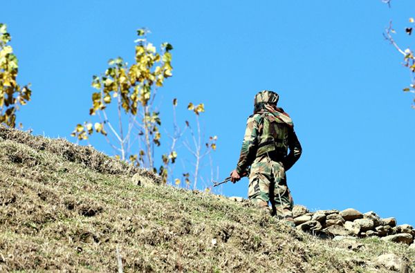 An Army jawan during search operation against the militants in Kupwara forests on Wednesday. -Excelsior/Aabid Nabi