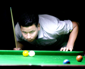 Cueist Tarun Rana aiming at target while locking horns with Mandeep Singh in the quarterfinal match of Jr Snooker District Championship at MA Stadium in Jammu. -Excelsior/Rakesh