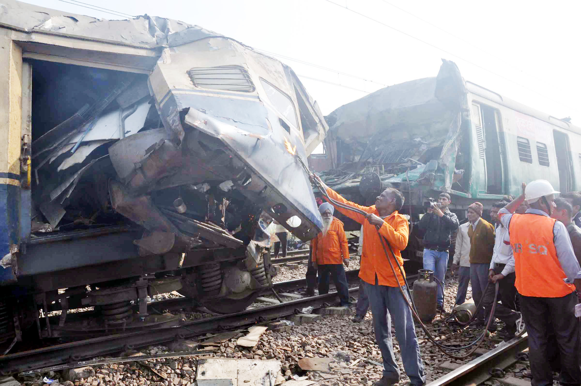 Railway officials engaged in removing damaged coaches of Lokmanya Tilak Express and EMU train which collided in Haryana's Palwal district on Tuesday morning, at least one person killed and over 100 injured in the accident.(UNI)