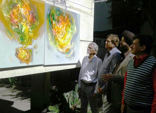 An artist showing his works to the guests during an Art Exhibition at Pune in Maharashtra.