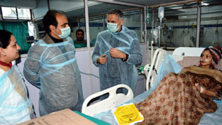 Deputy Commissioner Srinagar enquiring about health of a patient in a hospital.