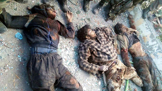 Bodies of three militants who were holed up inside the EDI building at Pampore in South Kashmir’s district of Pulwama on Monday. (UNI)