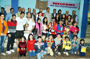 Winners posing for a group photograph alongwith dignitaries during valedictory function of 42nd J&K State Badminton Championship at Police Lines Badminton Hall in Jammu.