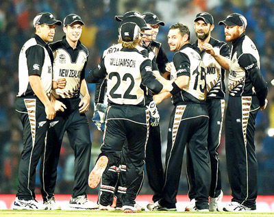 New Zealand players celebrate victory against India in the opening T20 World Cup match at Nagpur on Tuesday.