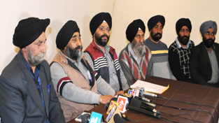 Members of All District Gurdwara Prabandhak Committee addressing a press conference in Srinagar on Wednesday. -Excelsior/ Photo