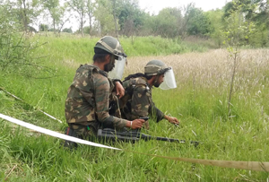 Army personnel engaged in de-mining operations at Lam in Nowshera sector of Rajouri district on Friday.