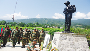 Army personnel paying tributes to martyr at Bhaderwah.